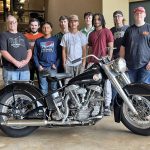 Collision Repair students pose with motorcycle.